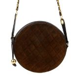 CHANEL - a vintage round quilted handbag. Featuring a brown quilted suede exterior with smooth brown