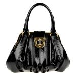 ALEXANDER MCQUEEN - a patent leather Elvie handbag. Featuring a black patent leather exterior,