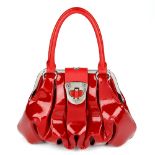 ALEXANDER MCQUEEN - a patent leather Elvie handbag. Featuring a red patent leather exterior,