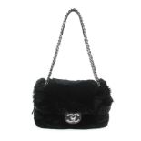 CHANEL - a Fur Flap handbag. Featuring a black coney fur exterior with black lambskin leather