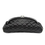 CHANEL - a Timeless clutch. Featuring a luxurious quilted black satin exterior, with smooth lambskin