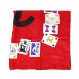 CHANEL - a silk scarf. Crafted from red silk, with a bold pattern of Chanel themed playing cards