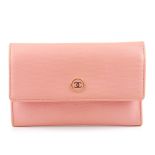 CHANEL - a pink purse. The grained pink leather exterior with enamel button with CC logo detail,