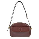 CARTIER - a Bordeaux crossbody handbag. Designed with a front flap pocket featuring maker's logo