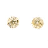 Two brilliant-cut diamonds, weighing 0.63 and 0.60ct. Estimated tinted yellow colour, P1-P3
