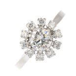 An 18ct gold diamond cluster ring. The brilliant-cut diamond, with similarly-cut diamond surround