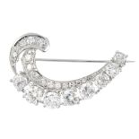 An 18ct gold diamond brooch. The graduated brilliant-cut diamond curved line, with similarly-cut