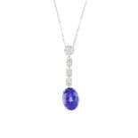 An 18ct gold tanzanite and diamond pendant. The oval-shape tanzanite, suspended from a brilliant-cut