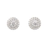 A pair of 18ct gold diamond cluster earrings. Each designed as a brilliant-cut diamond, within a