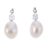 A pair of 18ct gold cultured pearl and diamond earrings. Each designed as a baroque cultured