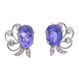 A pair of 18ct gold Ceylon colour-change sapphire and diamond earrings. Each designed as a cushion-