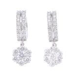 A pair of 18ct gold diamond earrings. Each designed as a brilliant-cut diamond floral cluster,