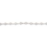 An 18ct gold diamond bracelet. Designed as a series of square-shape quatrefoil and brilliant-cut