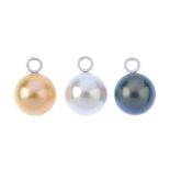 Three 18ct gold mounted cultured pearl pendants. Each designed as a single golden, grey-brown or