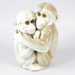 A Continental porcelain monkey group, probably Capodimonte, modelled as two embracing monkeys,