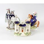 A group of Staffordshire pottery figures. To include three groups featuring dogs, a double-fronted