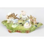 A collection of Beswick Beatrix Potter Storybook figurines. Comprising BP-1 gold circular