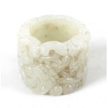 A Chinese white jade Banzhi ring, with carved decoration depicting dragons, 1.25 (3cm) diameter.