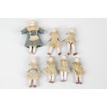 A group of eleven early 20th century German bisque miniature dolls. Comprising three 2.5 (6cm)