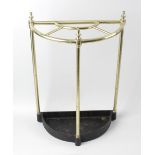 A brass and iron demi-lune stick stand. The semicircular tubular frame with central lunette division