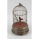 A singing caged bird automaton. The red-feathered bird, with working key-wound mechanism