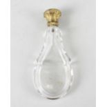 A 19th century yellow metal-topped glass scent bottle. The body of facetted teardrop form, the