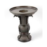 An Oriental bronze dish on stand. Of two-section design, the upper with removable dish having