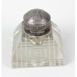 An impressive early 20th century heavy glass inkwell, with domed electroplated Britannia metal