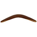 An Australian Aboriginal carved hardwood boomerang. The upper face incised with eight various