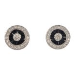 A pair of 18ct gold onyx and diamond earrings. Each designed as a brilliant-cut diamond, within a