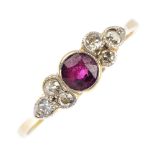 A mid 20th century 18ct gold ruby and diamond ring. The circular-shape ruby, with single-cut diamond