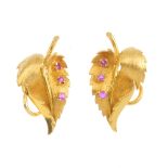 A pair of 1970s 18ct gold ruby earrings. Each designed as a textured leaf, with circular-shape