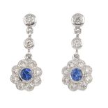 A pair of 18ct gold sapphire and diamond earrings. Each designed as a circular-shape sapphire,