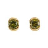 A pair of cubic zirconia stud earrings. Each designed as a circular-shape green cubic zirconia,