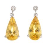 A pair of 18ct gold heliodor and diamond earrings. Each designed as a pear-shape heliodor, suspended