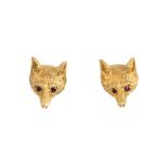 A pair of 1970s 9ct gold fox stud earrings. Each designed as a textured fox head, with red gem eye