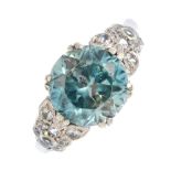 A zircon and gem-set dress ring. The circular-shape blue zircon, with colourless gem foliate