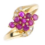 An 18ct gold ruby and diamond dress ring. The circular-shape ruby cluster, with brilliant-cut