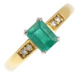 An 18ct gold emerald and diamond ring. The rectangular-shape emerald, with diamond accent shoulders.