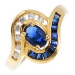 A sapphire and diamond crossover ring. The oval-shape sapphire, with brilliant-cut diamond and