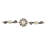 A late Victorian split pearl and diamond brooch. The split pearl and old-cut diamond cluster, with