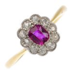 A mid 20th century 18ct gold ruby and diamond cluster ring. The cushion-shape ruby, with old-cut