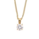 An 18ct gold diamond single-stone pendant. The brilliant-cut diamond, suspended from a tapered