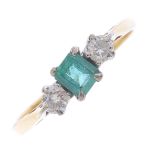 An 18ct gold emerald and diamond three-stone ring. The rectangular-shape emerald, with brilliant-cut