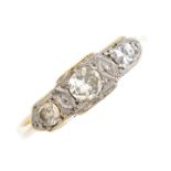 A mid 20th century 18ct gold and platinum diamond three-stone ring. The brilliant-cut diamond