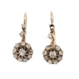 A pair of late Victorian diamond earrings. Each designed as an old-cut diamond cluster, suspended