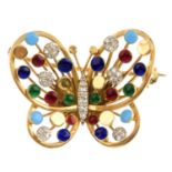 A diamond and enamel butterfly brooch. Of openwork design, the diamond body, with blue, red and
