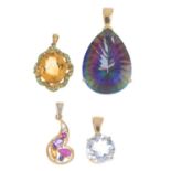 Four 9ct gold gem-set pendants. To include a citrine pendant with green garnet scrolling surround, a