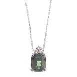 An 18ct gold tourmaline and diamond pendant. The cushion-shape green tourmaline, with brilliant-