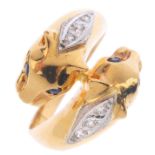 An 18ct gold diamond and sapphire panther ring. Designed as two panther heads, with brilliant-cut